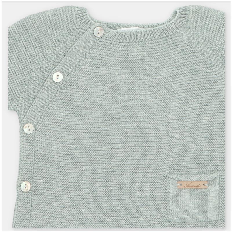 Light sage green knitted top featuring side buttons and a small pocket with a brand label.