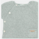 Light sage green knitted top featuring side buttons and a small pocket with a brand label.