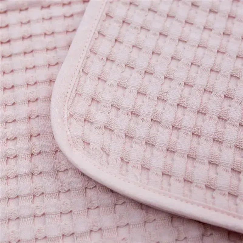 Lulujo Waffle Blanket by Mary Meyer in ballet slipper pink, featuring a textured woven design and soft edges.
