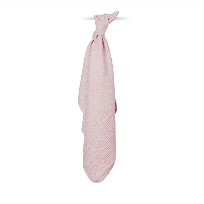 Waffle-knit blanket in ballet slipper pink, hanging with a tied knot at the top, showcasing a soft fabric texture.