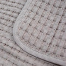Waffle texture of the Mary Meyer Lulujo blanket in sand color, featuring a smooth, rounded edge.