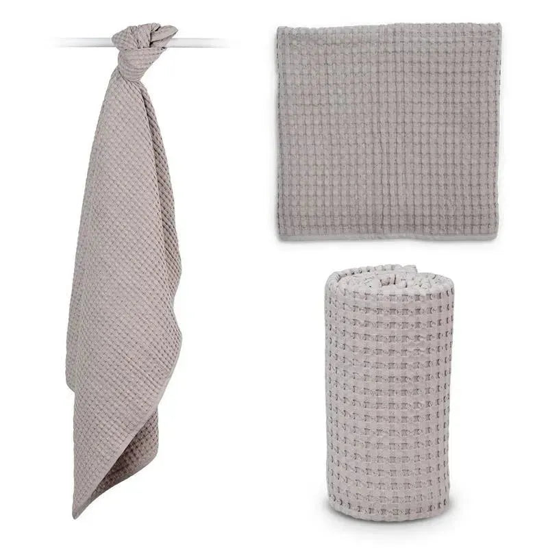 Lulujo Waffle Blanket in Sand, featuring a textured design, displayed in three forms: hanging, flat, and rolled.