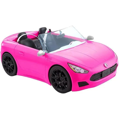 Bright pink Barbie toy convertible car with black wheels and seating for dolls, designed for imaginative play.
