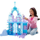 Disney Frozen Elsa Ice Castle playset features a child interacting with Olaf figure, showcasing details like icy structures and colorful furniture.