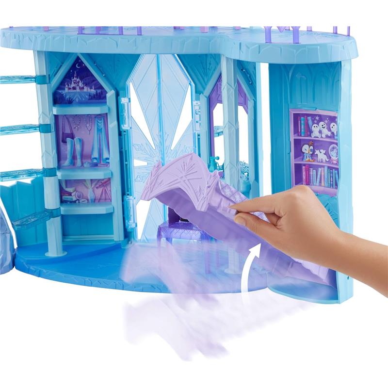 Disney Frozen Elsa Ice Castle Playset featuring a hand interacting with the playset, showcasing shelves and details inside.