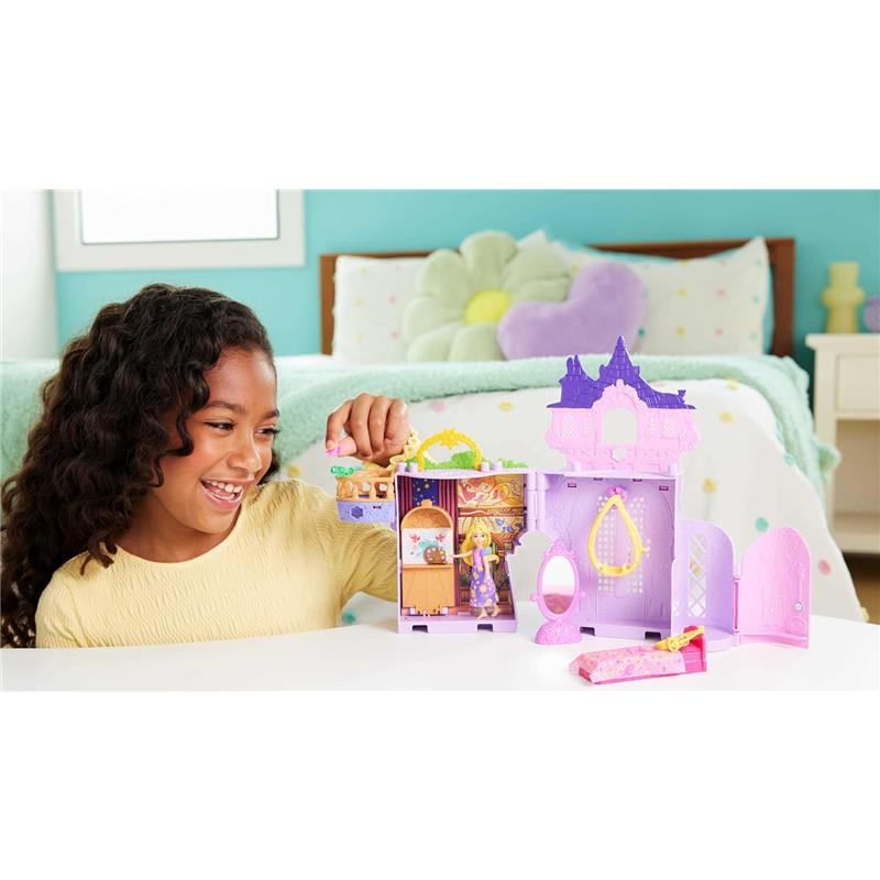 Child playing with the Mattel Disney Princess Stacking Castle featuring a Rapunzel figure and colorful castle accessories.