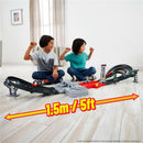 Children playing with the Mattel Hot Wheels Race Formula 1 Grand Prix Circuit Track Set, showing excitement and measuring length.