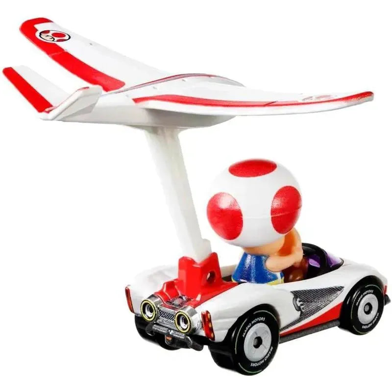 Toad character in a white and red Mario Kart glider with a tail wing, driving towards an adventure.