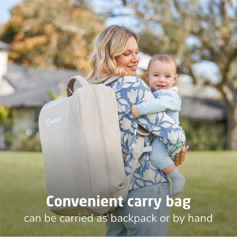 Maxi-Cosi Calao Travel Play Yard in Classic Graphite, shown as a carry bag on a woman’s back with a baby.