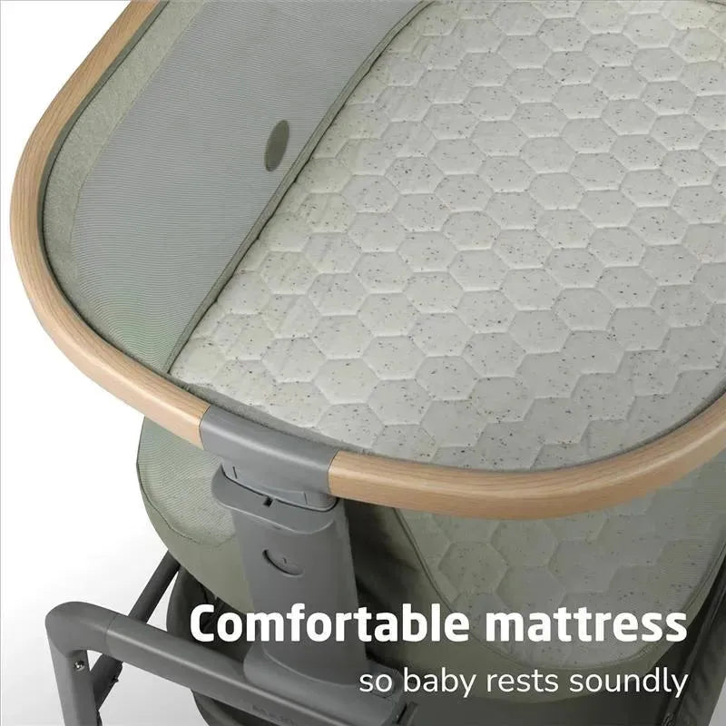 Maxi-Cosi Iora Bassinet features a comfortable hexagonal-patterned mattress and a wooden edge, promoting restful sleep for babies.