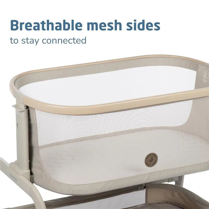 Classic Oat Maxi-Cosi Iora bedside bassinet featuring breathable mesh sides for visibility and connection.
