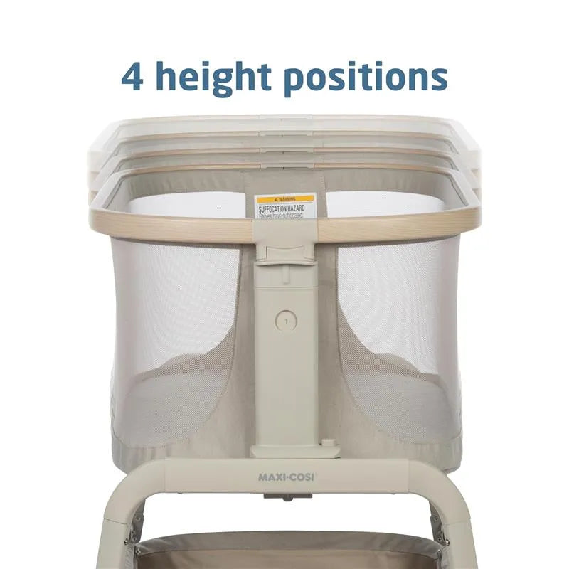 Maxi-Cosi Iora Bedside Bassinet in Classic Oat with a sturdy frame, mesh sides, and adjustable height settings.