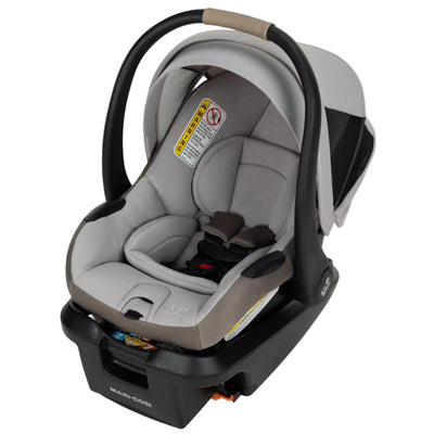 Maxi-Cosi Mico Pro+ Infant Car Seat in Oyster Shell color featuring a safe, padded design with harness and carry handle.