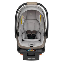 Maxi-Cosi Mico Pro+ infant car seat in oyster shell color, featuring a padded interior, harness system, and safety warning labels.