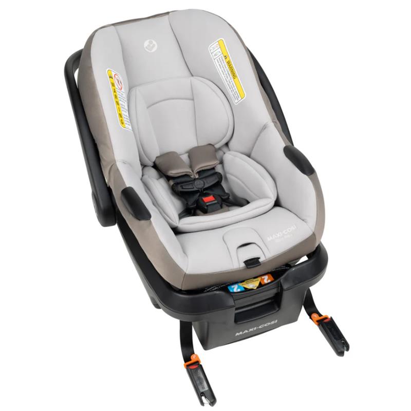 Maxi-Cosi Mico Pro+ infant car seat in oyster shell color, featuring a padded design, safety harness, and base attachment system.
