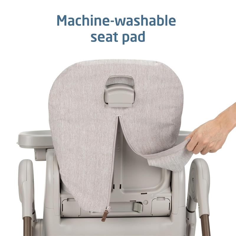 Machine-washable seat pad being removed from the back of a Maxi-Cosi Minla 6-in-1 high chair in truffle color.