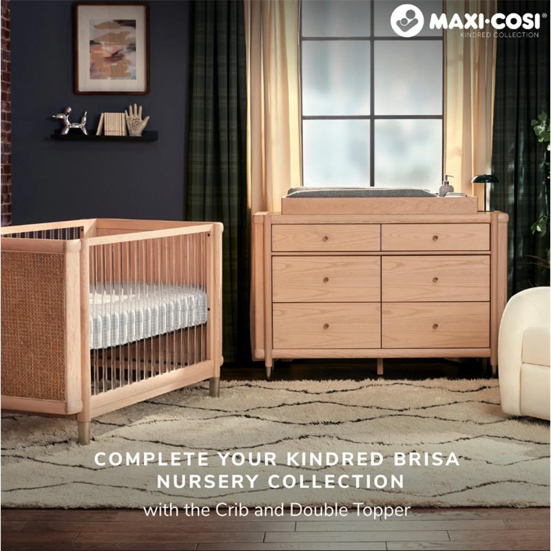 Maxi-Cosi Brisa 6-Drawer Dresser in Onyx Heritage next to a crib, featuring a changing top and stylish wooden design.