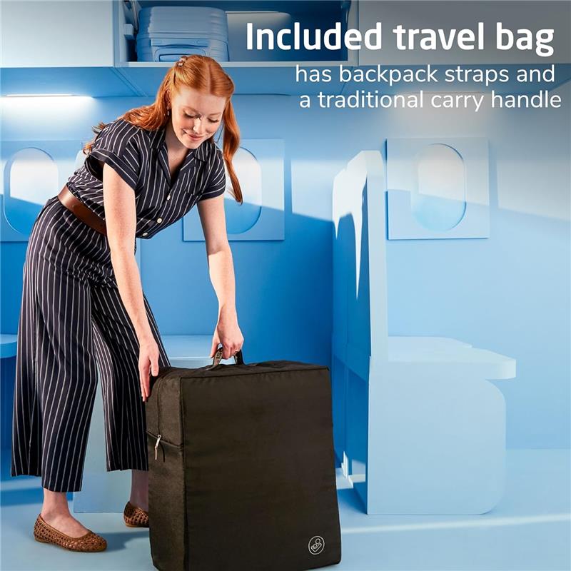 A woman in a striped outfit lifts a black travel bag with backpack straps, highlighting its portability and convenience.