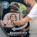Maxi-Cosi Peri 180 Rotating Infant Car Seat in Desert Wonder with a child being secured, showcasing the 180° rotation feature.