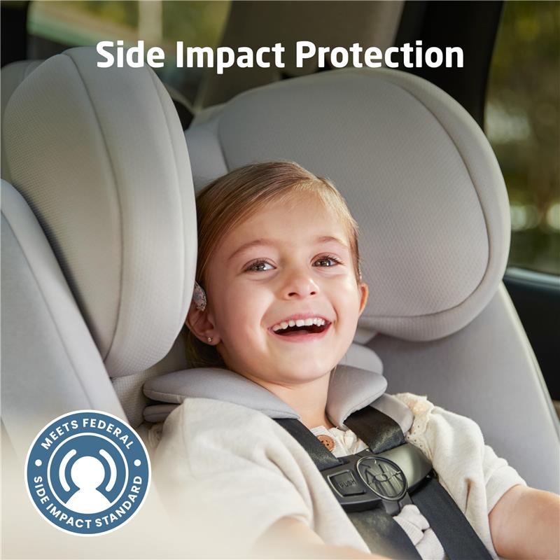 Child smiling in a Maxi-Cosi Pria All-in-One Convertible Car Seat with visible side impact protection feature.
