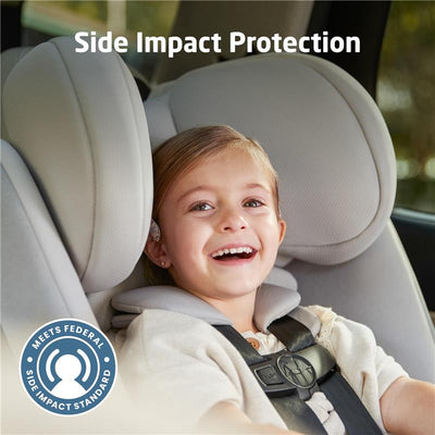 Child smiling in a Maxi-Cosi Pria All-in-One Convertible Car Seat with visible side impact protection feature.