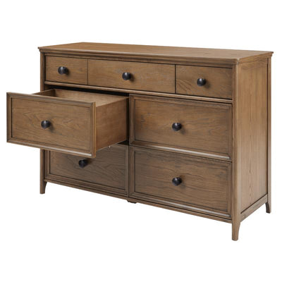 Maxi Cosi Quiet Luxury 7-drawer dresser in a warm wood finish, featuring six closed drawers and one partially opened drawer.
