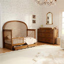 Maxi Cosi Quiet Luxury 7-Drawer Dresser displayed in a cozy nursery with a wooden crib, soft textiles, and decorative elements.