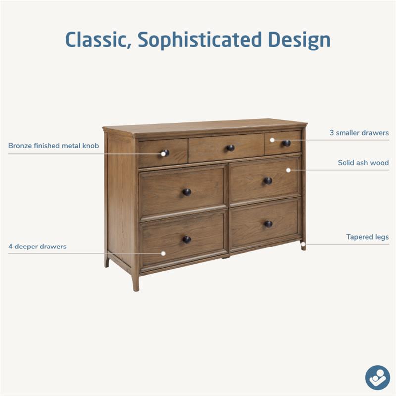 Maxi Cosi Quiet Luxury 7-Drawer Dresser in solid ash wood, featuring 3 smaller and 4 deeper drawers with bronze knobs and tapered legs.