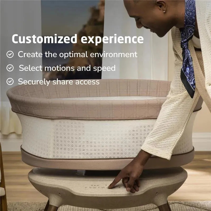 Smart bassinet, showing a person adjusting settings for customized experience, featuring soft fabric and neutral colors.
