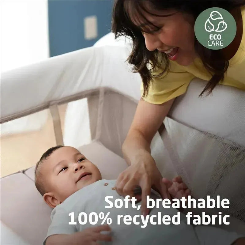 Maxi-Cosi Swift Play Yard in Classic Green with a parent interacting with a baby. Features soft, breathable 100% recycled fabric.