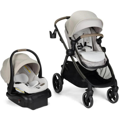 Maxi-Cosi Zelia Pro 5-in-1 Travel System in Classic Oat, featuring a stroller and infant car seat, both in soft beige and white.