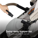 Hand reaching for the swing-away bumper bar of the Maxi-Cosi Zelia Pro 5-in-1 Travel System in Classic Oat, facilitating easy baby access.