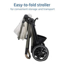 Easy-to-fold stroller in Classic Oat color, designed for convenient storage and transport, showing a compact profile.