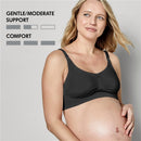 Black Medela maternity and nursing bra model displayed on a pregnant woman, with gentle/moderate support and comfort indicators shown.