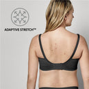 Maternity and nursing bra in black, showing adaptive stretch feature on model from the back, highlighting adjustable straps and hook closure.