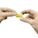 Hands holding a yellow Medela membrane spare part, demonstrating its removal or installation process.