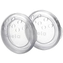 Clear Medela breast shells designed for comfort, featuring circular shape and small holes for ventilation.