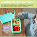 Bento box in blue mint with two compartments, one with pasta and the other with strawberries, held by a child using a fork.