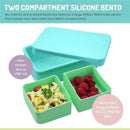 100% silicone bento box in blue mint, with a main compartment (23.6 oz) and two removable compartments (10 oz each) filled with food.