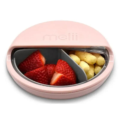 Melii pink snack container with three compartments, featuring strawberries and snack puffs inside.