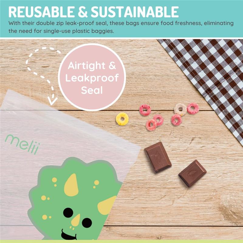 Reusable Melii sandwich and snack bag featuring a dinosaur design, with chocolate and snacks displayed on a wooden table.