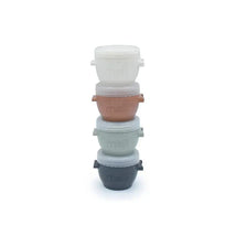 Four Melii baby food storage containers in earth tones, stacked with lids, each 4 oz in size.