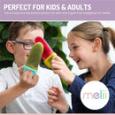 Two children enjoying colorful ice pops, one green and one red, smiling and playfully interacting.
