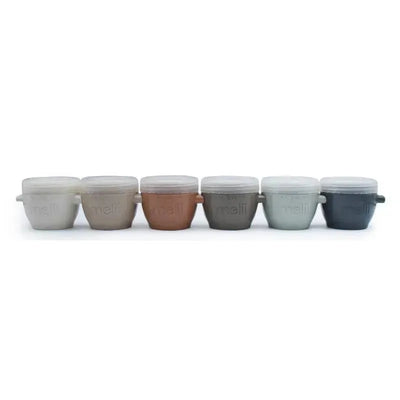 Six 2 oz Melii baby food storage containers with lids in earth tones, featuring labels and ergonomic handles.