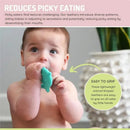 Baby holding a teal silicone teether shaped like a dinosaur, promoting sensory adaptation and reducing picky eating.