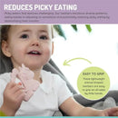 A smiling toddler holds a pink unicorn-shaped silicone teether, promoting sensory development and easing picky eating.
