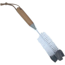 Bamboo baby bottle brush with a wooden handle, white bristles, and a sponge tip for cleaning bottles.