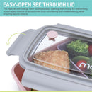 Bento box in pink, purple, and grey with removable compartments, featuring a clear lid and a sandwich with vegetables inside.