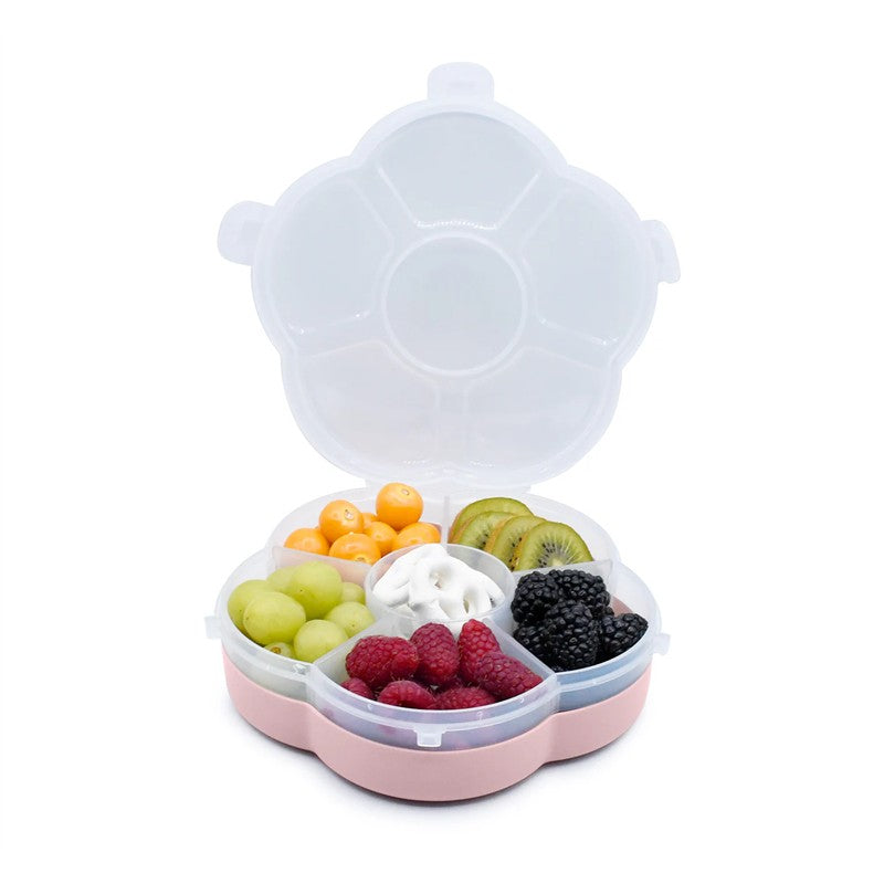 Snackle Box in pink, featuring sections filled with grapes, raspberries, kiwifruit, blackberries, and yogurt.