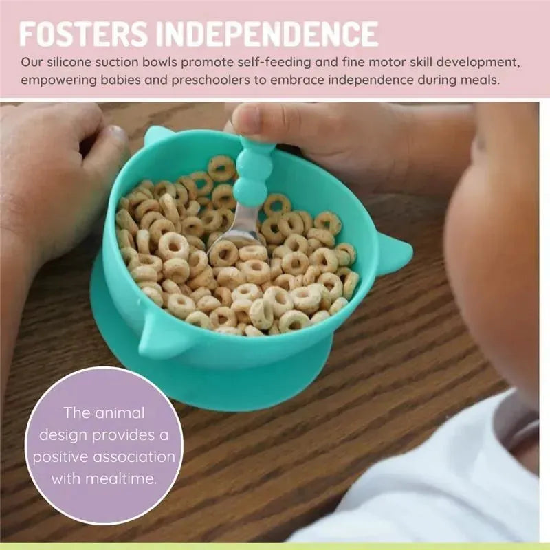 Silicone suction bowl in shark blue filled with cereal, held by a child encouraging self-feeding and fine motor skills.